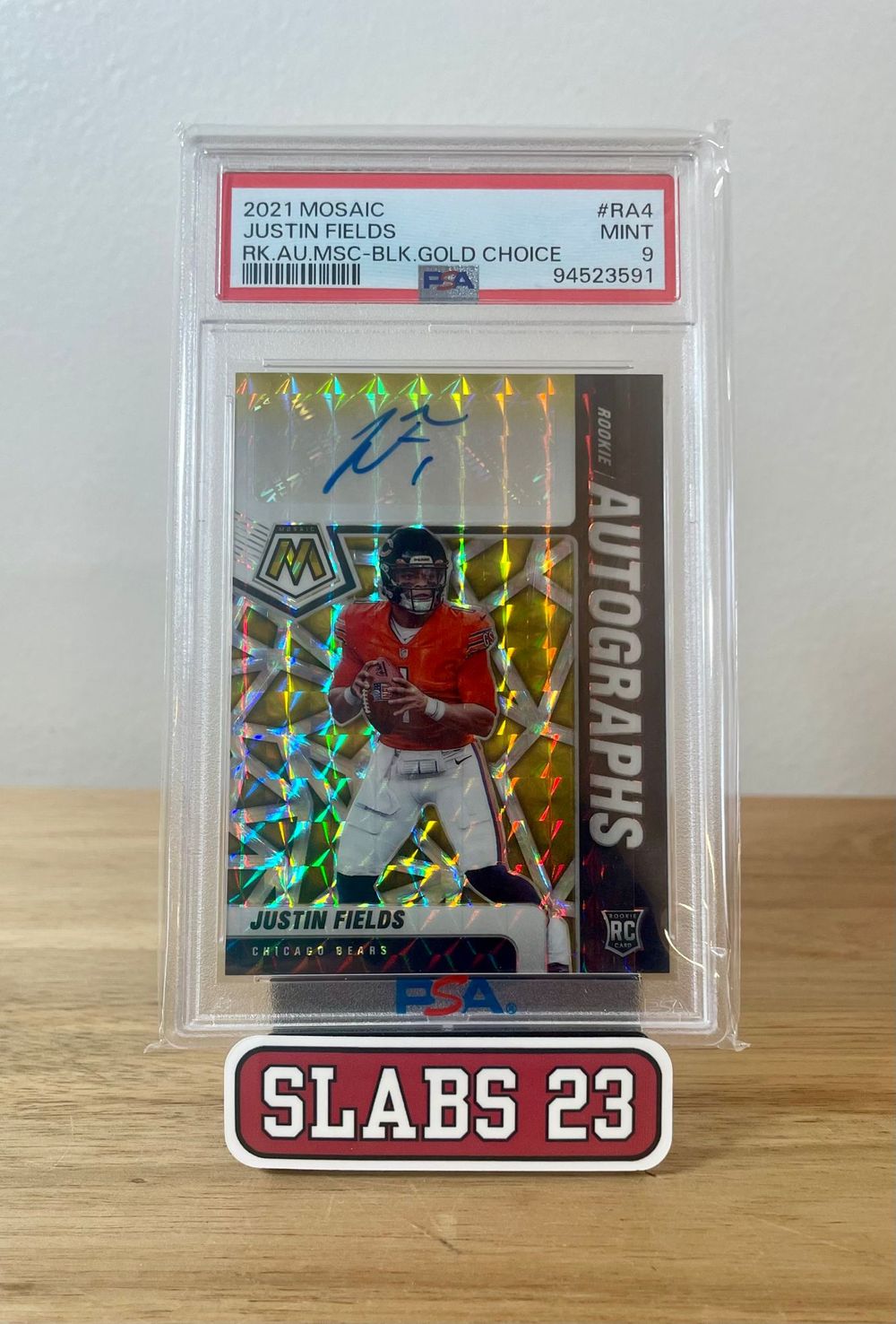 Justin Fields 2021 Mosaic rookie autograph, Black Gold Choice parallel, PSA 9 Mint, on a Slabs 23 stand